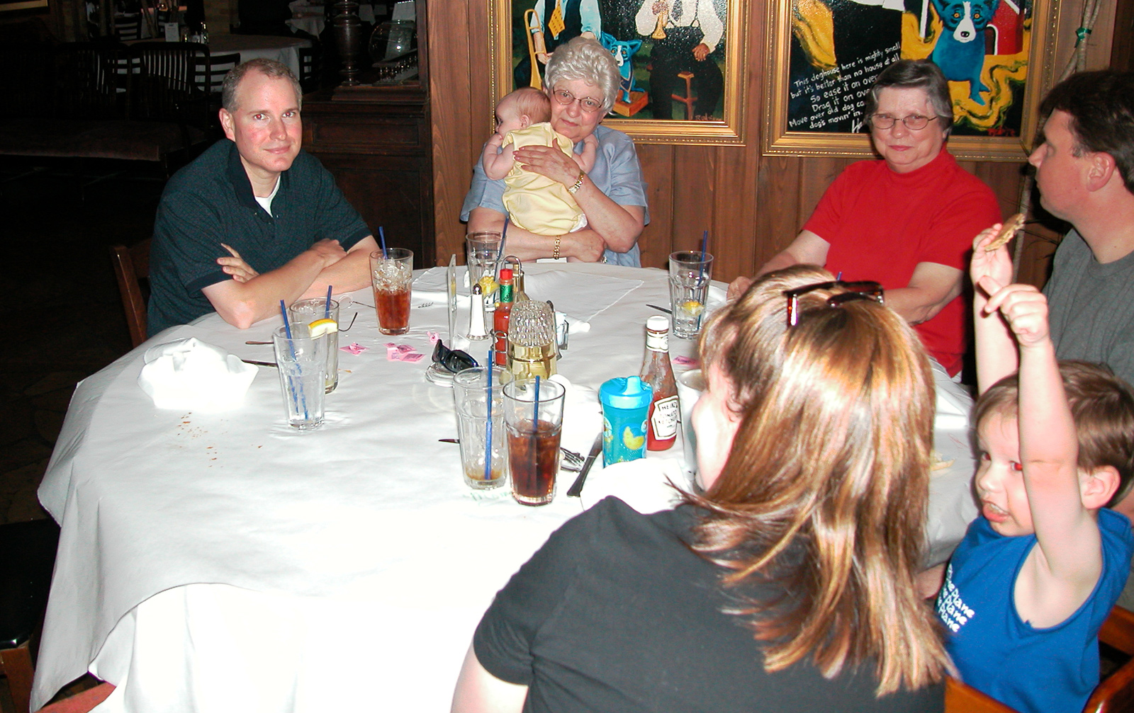 Marc, Mom holding Rhianna, Aunt Dory, Rochelle holding Miles, and Paul helping Marc celebrate his Birthday at the BLUE DOG® restaurant in Lafayette
