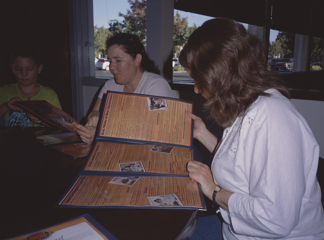 John, Jackie, and Carol reading the menu at EDDIE PAPA'S AMERICAN HANGOUT®